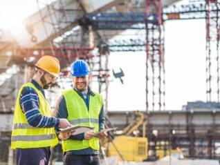 two construction workers conducting a survey