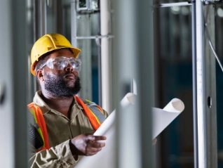 construction worker reviewing drawings