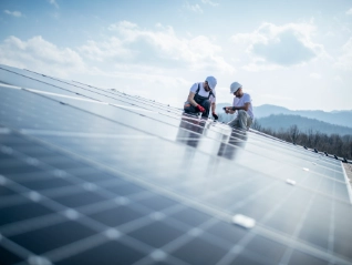 Two engineers installing solar panels