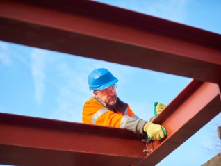 construction worker erecting girders