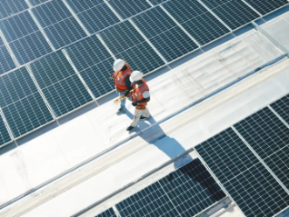 Two solar panel workers walking