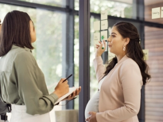 pregnant woman talking to woman and man