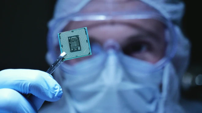 holding up a microchip in closeup