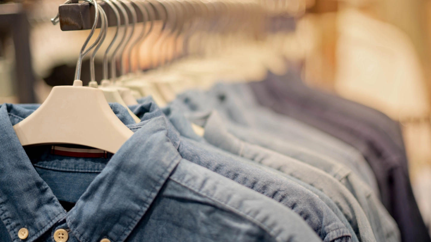 A clothes rack of men's shirts hanging up