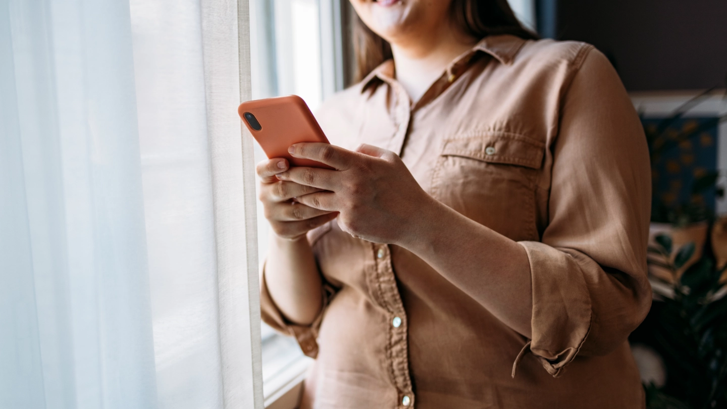Young woman checking her mobile in the office