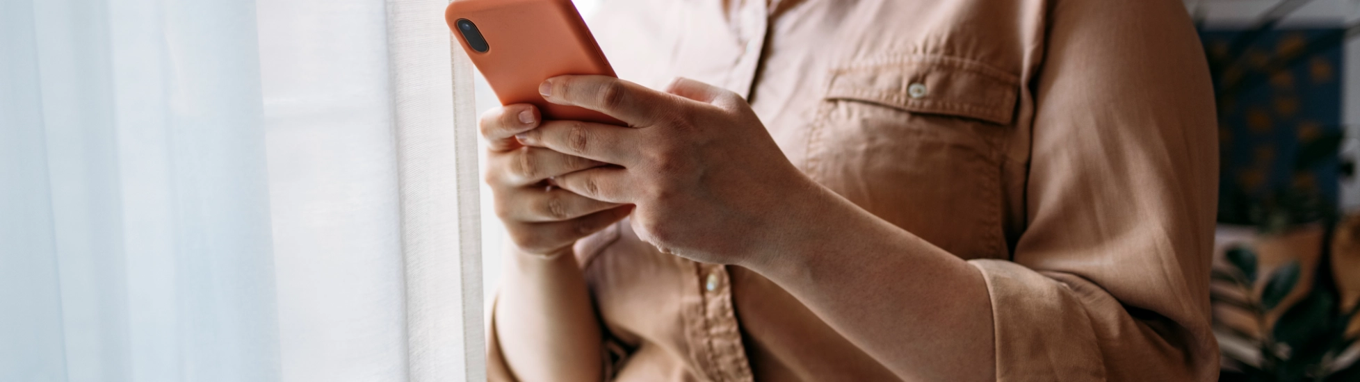 Young woman checking her mobile in the office